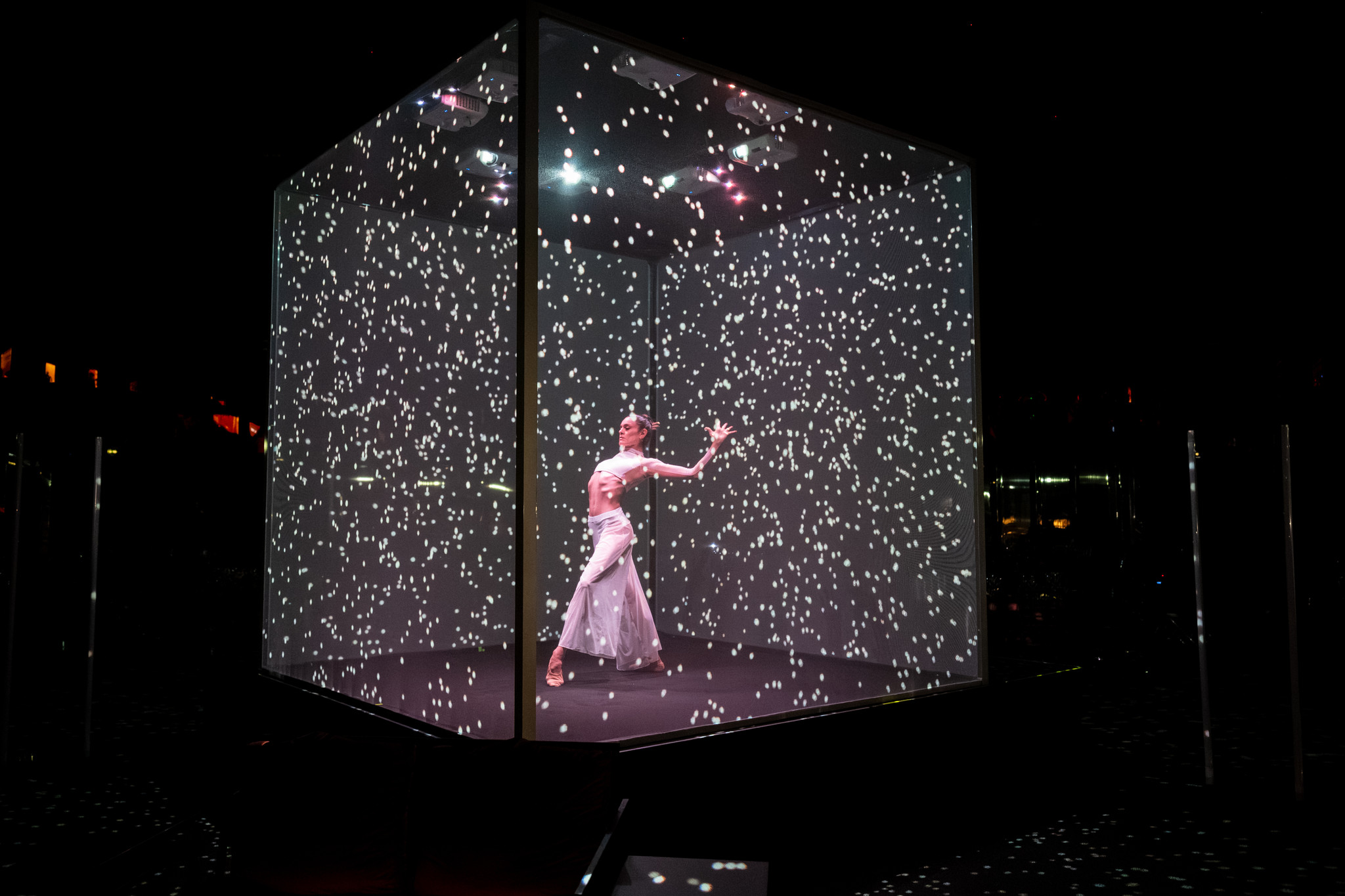 Artist dancing inside a large cubic structure with white holographic details that change over time - ACCAELLE Events | Organizzazione eventi e Wedding planner