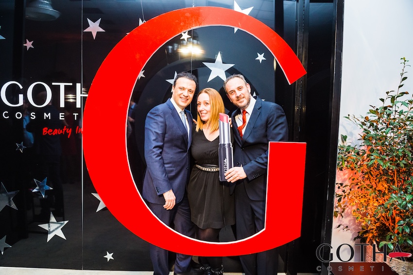 Group of people in elegant attire in front of the customized Gotha Cosmetics logo - ACCAELLE Events | Organizzazione eventi e Wedding planner