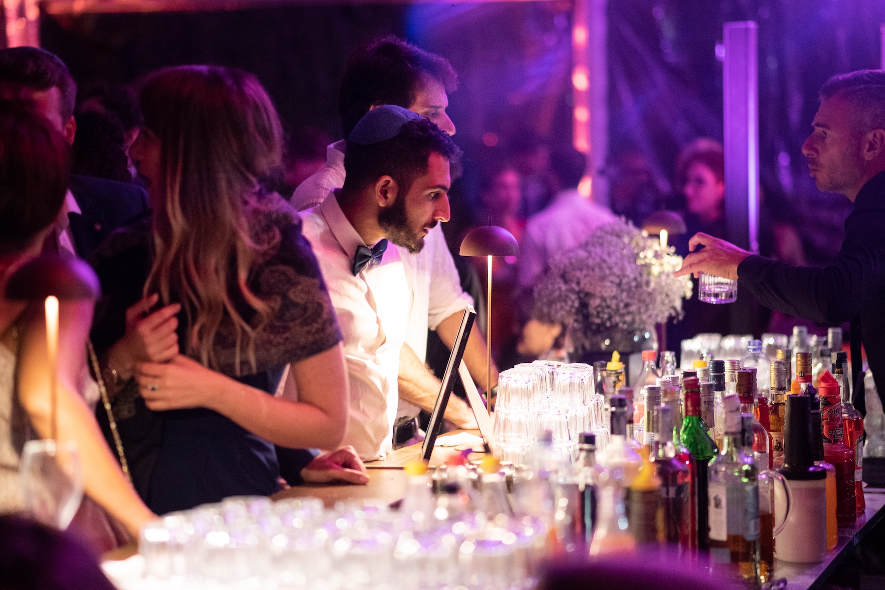 Guests at an evening event in a festive setting with atmospheric lighting - ACCAELLE Events | Organizzazione eventi e Wedding planner