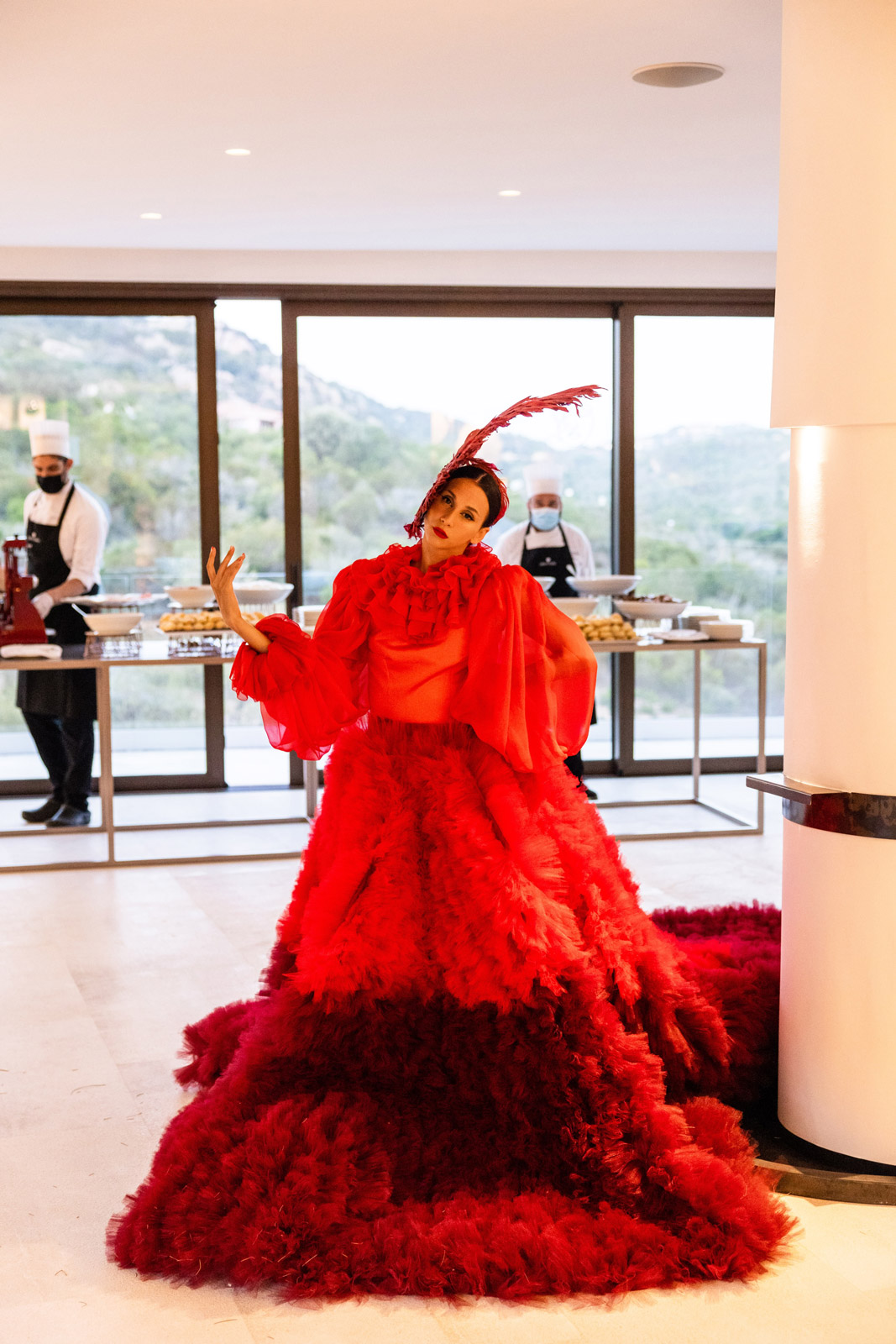 Performer in a voluminous red dramatic dress during an indoor show - ACCAELLE Events | Organizzazione eventi e Wedding planner