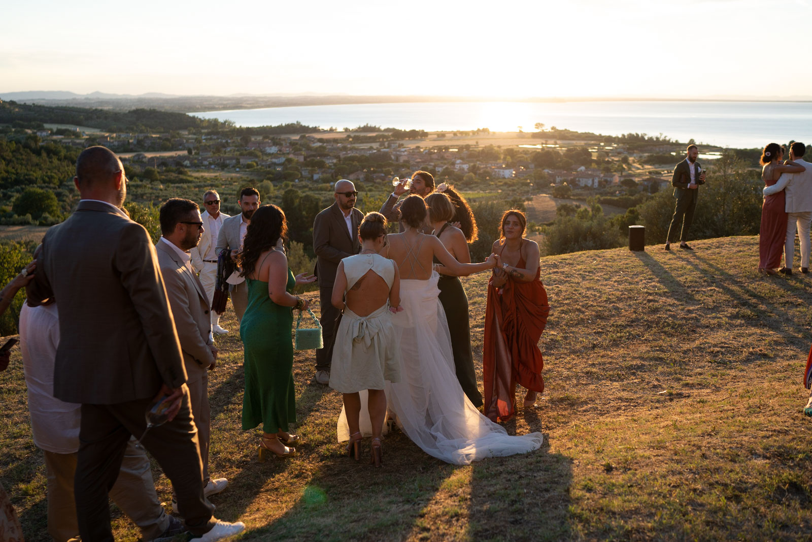 Bride with guests in a garden with a seascape in the background at night - ACCAELLE Events | Organizzazione eventi e Wedding planner